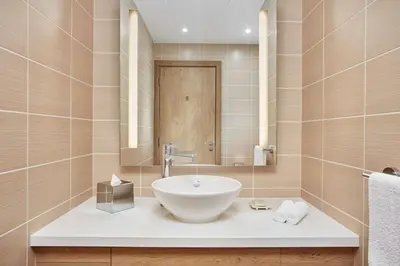 a bathroom with a bowl sink and a mirror at Hilton Garden Inn Dubai, Mall Avenue in Dubai