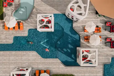 an aerial view of a toy swimming pool with boats at V Hotel Dubai, Curio Collection by Hilton in Dubai