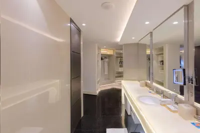 a bathroom with two sinks and a large mirror at V Hotel Dubai, Curio Collection by Hilton in Dubai