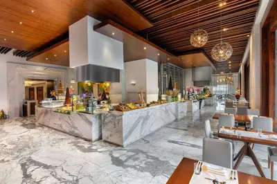 a lobby of a hotel with a breakfast buffet at Hilton Dubai Al Habtoor City in Dubai