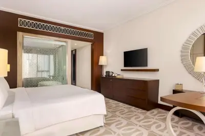 a hotel room with a bed and a television at Hilton Dubai Al Habtoor City in Dubai