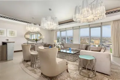 a living room with chandeliers and a large living room at Hilton Dubai Al Habtoor City in Dubai
