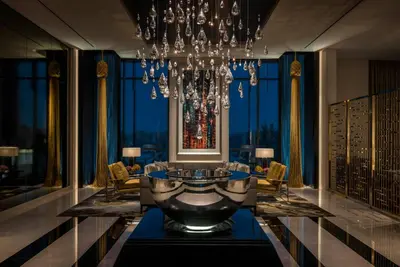 a large room with a chandelier and a table at Four Seasons Hotel Dubai International Financial Centre in Dubai
