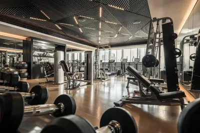 a gym with lots of weights and cardio equipment at Four Seasons Hotel Dubai International Financial Centre in Dubai
