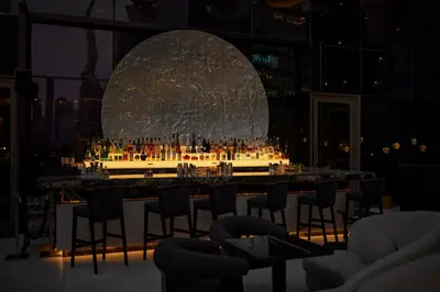 a bar with chairs and a large orb in a room at Four Seasons Hotel Dubai International Financial Centre in Dubai