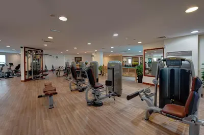 a gym with a lot of treadmills and exercise equipment at MD Hotel By Gewan in Dubai
