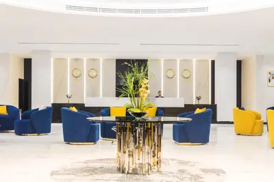 a lobby with a table and blue chairs at MD Hotel By Gewan in Dubai