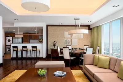 a living room and kitchen with a couch and a table at La Suite Dubai Hotel & Apartments in Dubai