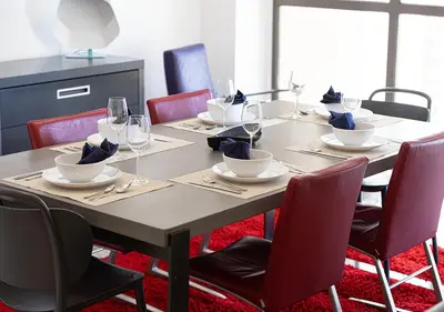 a wooden table with chairs and wine glasses on it at Luxury Sea View Beachfront 3 Bedroom Apt, JBR in Dubai