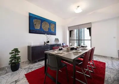 a dining room with a table and chairs at Luxury Sea View Beachfront 3 Bedroom Apt, JBR in Dubai