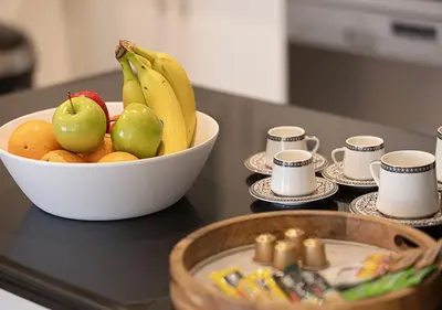a bowl of fruit on a counter with a bowl of apples and bananas at Luxury Sea View Beachfront 3 Bedroom Apt, JBR in Dubai