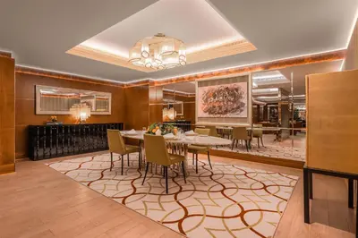a dining room with a table and chairs at The Meydan Hotel Dubai in Dubai