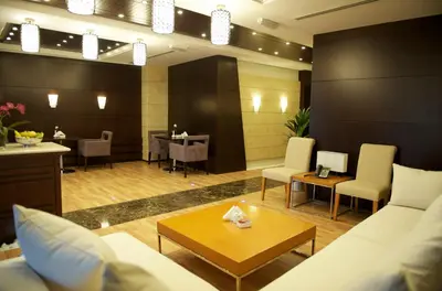 a living room with a couch and a table at Grand Bellevue Hotel Apartment Dubai in Dubai