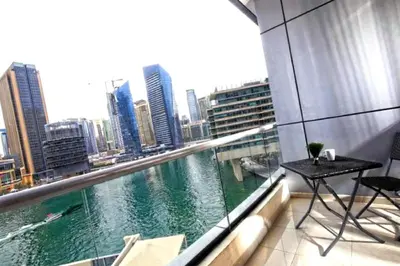 a balcony with a view of a river in a city at One Bedroom Apartment - Bay Central Tower in Dubai