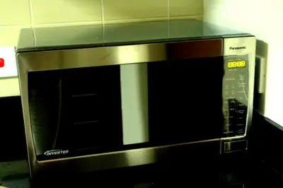a microwave oven sitting on top of a counter at One Bedroom Apartment - Bay Central Tower in Dubai