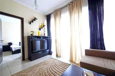 a living room with a television and a couch at One Bedroom Apartment - Bay Central Tower in Dubai