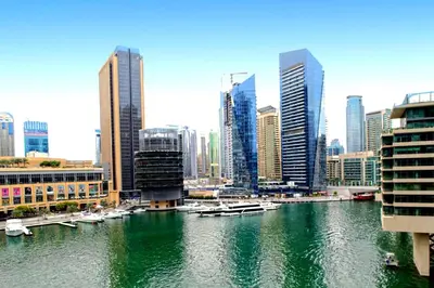a view of a city with boats in the water at One Bedroom Apartment - Bay Central Tower in Dubai