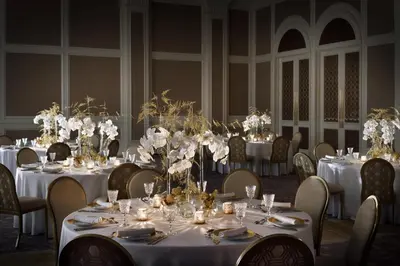 a group of tables with white flowers on them at Kempinski The Boulevard Dubai in Dubai