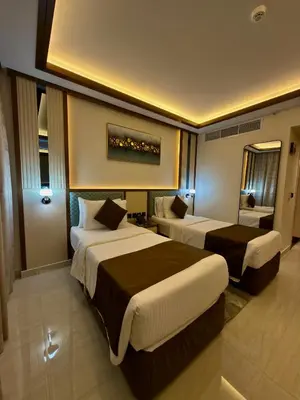 a hotel room with two beds in a room at Smana Hotel Al Raffa in Dubai