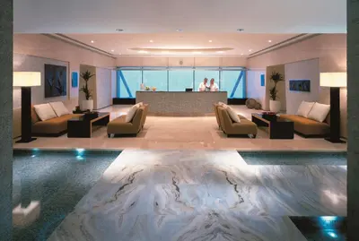 a hotel lobby with a pool in the middle of the room at Shangri-La Dubai in Dubai