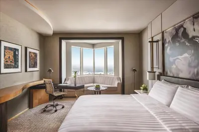 a bedroom with a bed and a desk and a chair at Shangri-La Dubai in Dubai