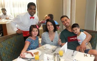 a family sitting at a table in a restaurant at Savoy Crest Hotel Apartments in Dubai