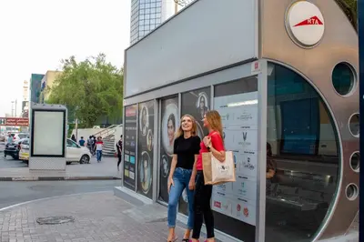 two women are standing outside of a store at Savoy Crest Hotel Apartments in Dubai
