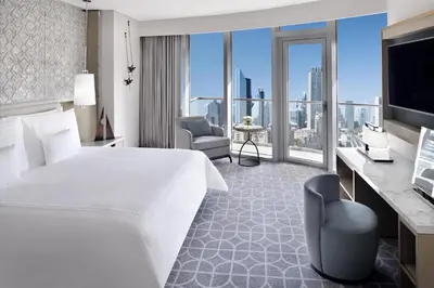 a hotel room with a large bed and a television at Kempinski Central Avenue Dubai in Dubai