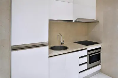 a kitchen with a sink and a stove at Kempinski Central Avenue Dubai in Dubai