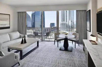 a living room with a couch and a table at Kempinski Central Avenue Dubai in Dubai