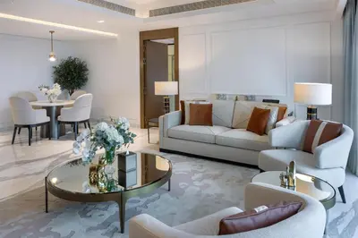 a living room with a couch and a table at Kempinski Central Avenue Dubai in Dubai