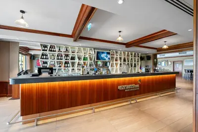 a bar in the middle of a room at Arabian Ranches Golf Club in Dubai