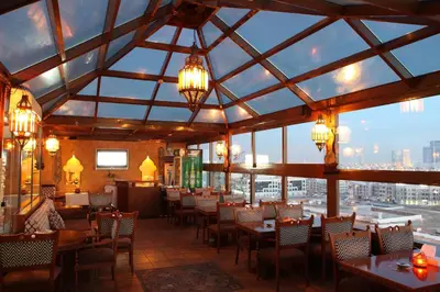 a restaurant with tables and chairs and a view of the city at Sea View Hotel Dubai in Dubai
