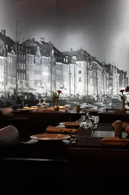 a black and white photo of a table with tables and buildings at Sea View Hotel Dubai in Dubai