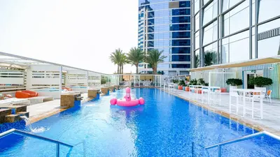 a pool with a pink raft in the middle of a building at Media One Hotel in Dubai