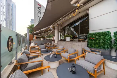 a row of tables and chairs on a patio at Media One Hotel in Dubai