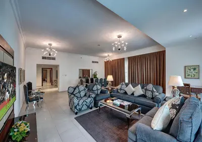 a large living room with couches and a table at Marina Hotel Apartments in Dubai