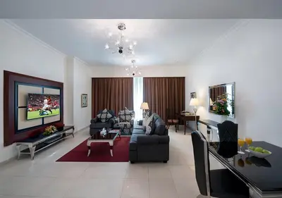 a living room with a couch and a tv at Marina Hotel Apartments in Dubai