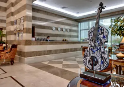 a violin sitting on a table in a lobby at Marina Hotel Apartments in Dubai