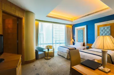 a hotel room with a bed and a desk at Social Hotel in Dubai