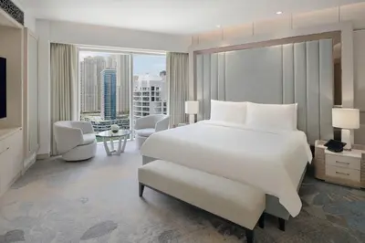 a bedroom with a large white bed and a large window at JW Marriott Hotel Marina in Dubai