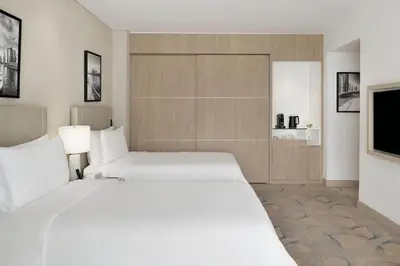 a hotel room with two beds and a flat screen tv at JW Marriott Hotel Marina in Dubai
