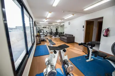 a gym with treadmills and exercise bikes in a room at Welcome Hotel Apartments 1 in Dubai