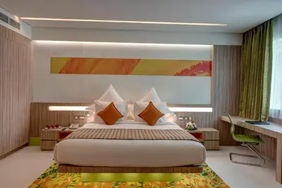 a bedroom with a large bed and a desk at Al Khoory Atrium in Dubai