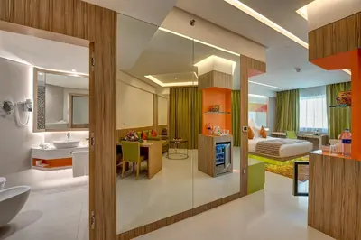 a bathroom with a sink and a bedroom at Al Khoory Atrium in Dubai