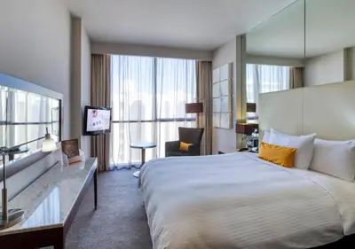 a hotel room with a large bed and a television at Centro Barsha - by Rotana in Dubai