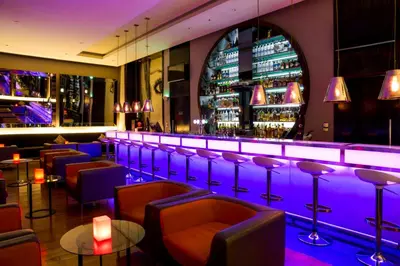 a bar with purple lighting in a restaurant at Centro Barsha - by Rotana in Dubai