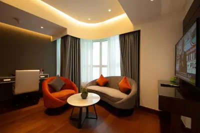 a living room with two chairs and a television at Number One Tower Suites in Dubai