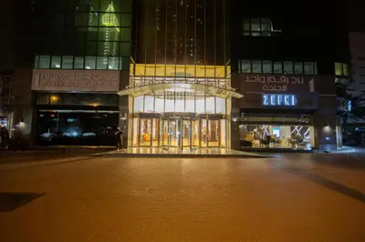 an empty street in front of a building at night at Number One Tower Suites in Dubai
