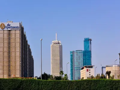 a group of tall buildings in a city at The Apartments, Dubai World Trade Centre in Dubai